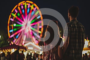 man, woman, and a blend of litup ferris wheel