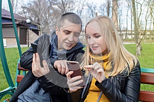 Man and a woman are both sitting on a date and sipping into their smartphones. Concept of social media addiction, getting out of