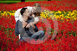 Man and woman in braces laughing in the flowers
