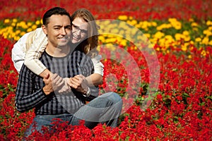 Man and woman in brackets laughing in the flowers