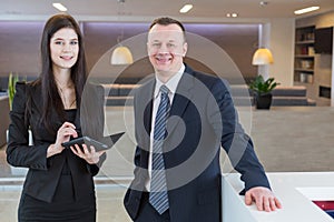 Man and woman in business suits standing at the reception photo