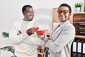 Man and woman business workers drinking coffee at office