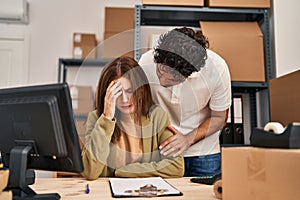 Man and woman business workers with sad expression working at office