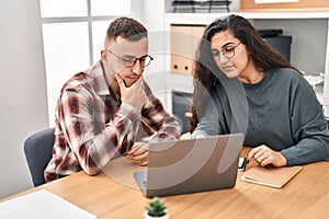 Man and woman business workers using laptop working at office