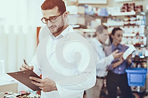 Man and woman buys a medicaments in pharmacy