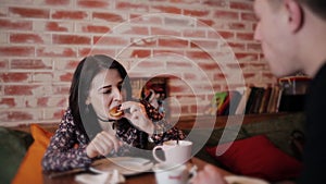 Man and woman in cafe drink coffee and croissants