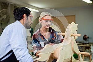 Man and woman carpenter using electric drill working make furniture, Carpenter to work in wood factory. owner woodworker handmade