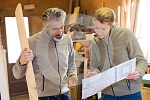 Man and woman at carpenter workshop