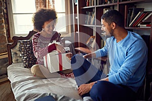Man and woman celebrating  Christmas and exchange gift