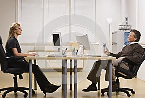 Man and Woman Chatting in Office photo