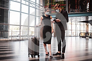 Man and woman checking their boarding passes