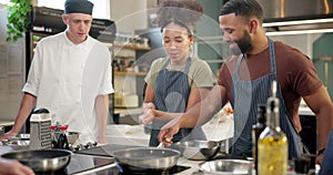 Man, woman and chef for cooking class in kitchen restaurant or culinary, experience or teaching. Professional, students