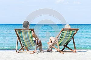 Man and woman chilling on a summer beach