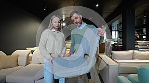 A man and woman choosing chair in furniture store