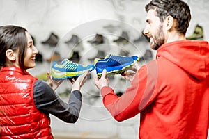 Man and woman choosing shoes for hiking