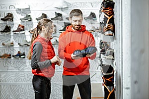 Man and woman choosing shoes in the shop