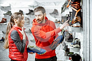 Man and woman choosing shoes in the shop
