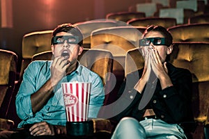 Man and woman in the cinema watching a 3D movie