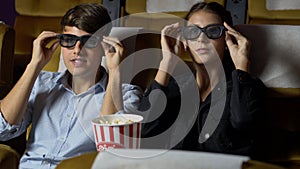 Man and woman in the cinema watching a 3D movie