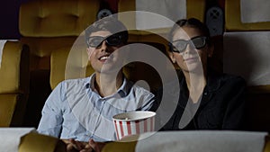 Man and woman in the cinema watching a 3D movie