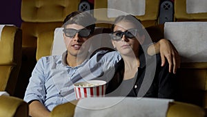 Man and woman in the cinema watching a 3D movie