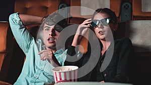 Man and woman in the cinema watching a 3D movie