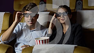 Man and woman in the cinema watching a 3D movie