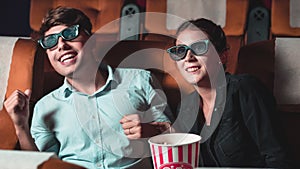 Man and woman in the cinema watching a 3D movie