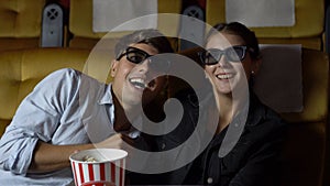 Man and woman in the cinema watching a 3D movie