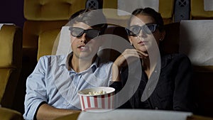 Man and woman in the cinema watching a 3D movie