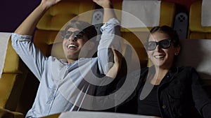 Man and woman in the cinema watching a 3D movie