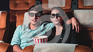 Man and woman in the cinema watching a 3D movie