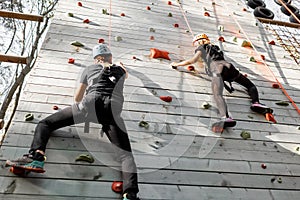 Man and woman climbing the wall in the park