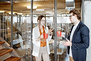 Man and woman during the coffee break in the office