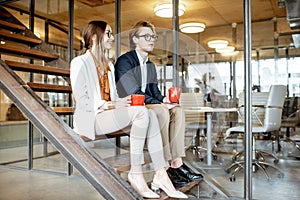 Man and woman during the coffee break in the office