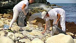 Man and Woman Collecting Rubbish on the Beach