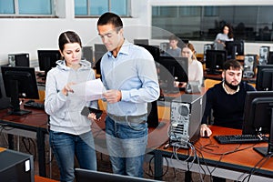 Man and woman communicating at computer class