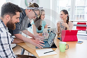 Man and woman cooperating as co-workers in collaborative office photo