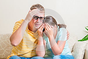 Man and woman on the couch watching scary movie