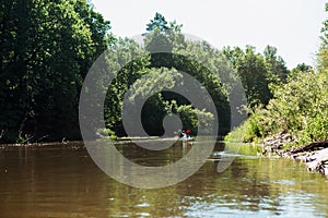 Man and woman couple in family kayak trip rowing boat on the river, a water hike, a summer adventure. Eco-friendly and extreme