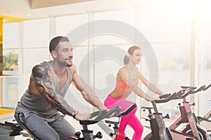 Man and woman, couple in gym on exercise biles