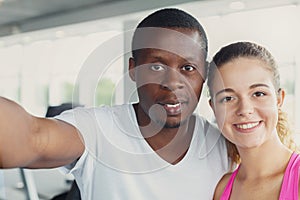 Man and woman, couple in gym making selfie