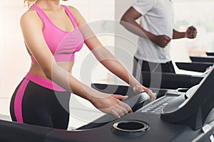 Man and woman, couple in gym on treadmills