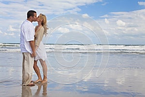 Man & Woman Couple Holding Hands Kissing On Beach