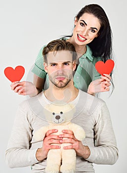 Man and woman couple in love hold red heart valentines cards white background. Man and pretty girl in love. Valentines