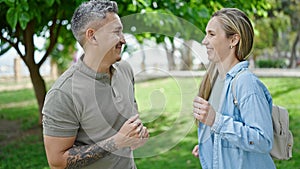 Man and woman couple smiling confident dancing at park