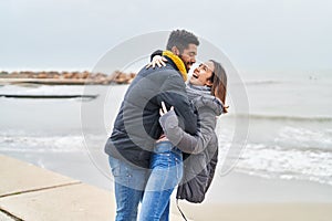 Man and woman couple smiling confident dancing at seaside