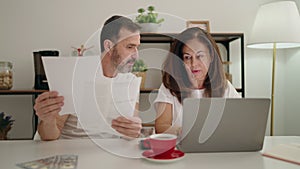 Man and woman couple using laptop teleworking at home