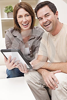 Man & Woman Couple Using Tablet Computer at Home