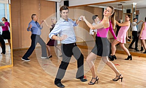 Man and woman dancing jive as couple in dance studio